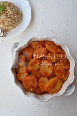 Potato tray sits beside a plate of rice