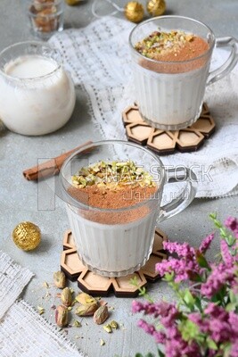 Cup of sahlab with cinnamon and nuts on it