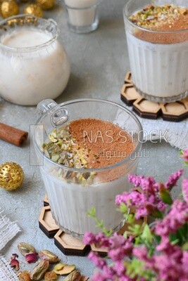 Cup of sahlab with cinnamon and nuts on it