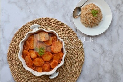 Potato tray sits beside a plate of rice