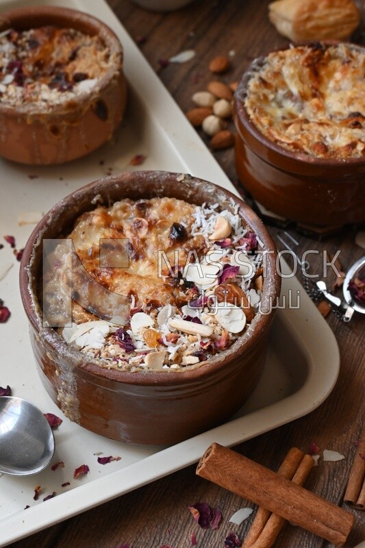 Plate of Umm Ali with nuts on it, famous oriental Arabic sweets, bread and milk sweets