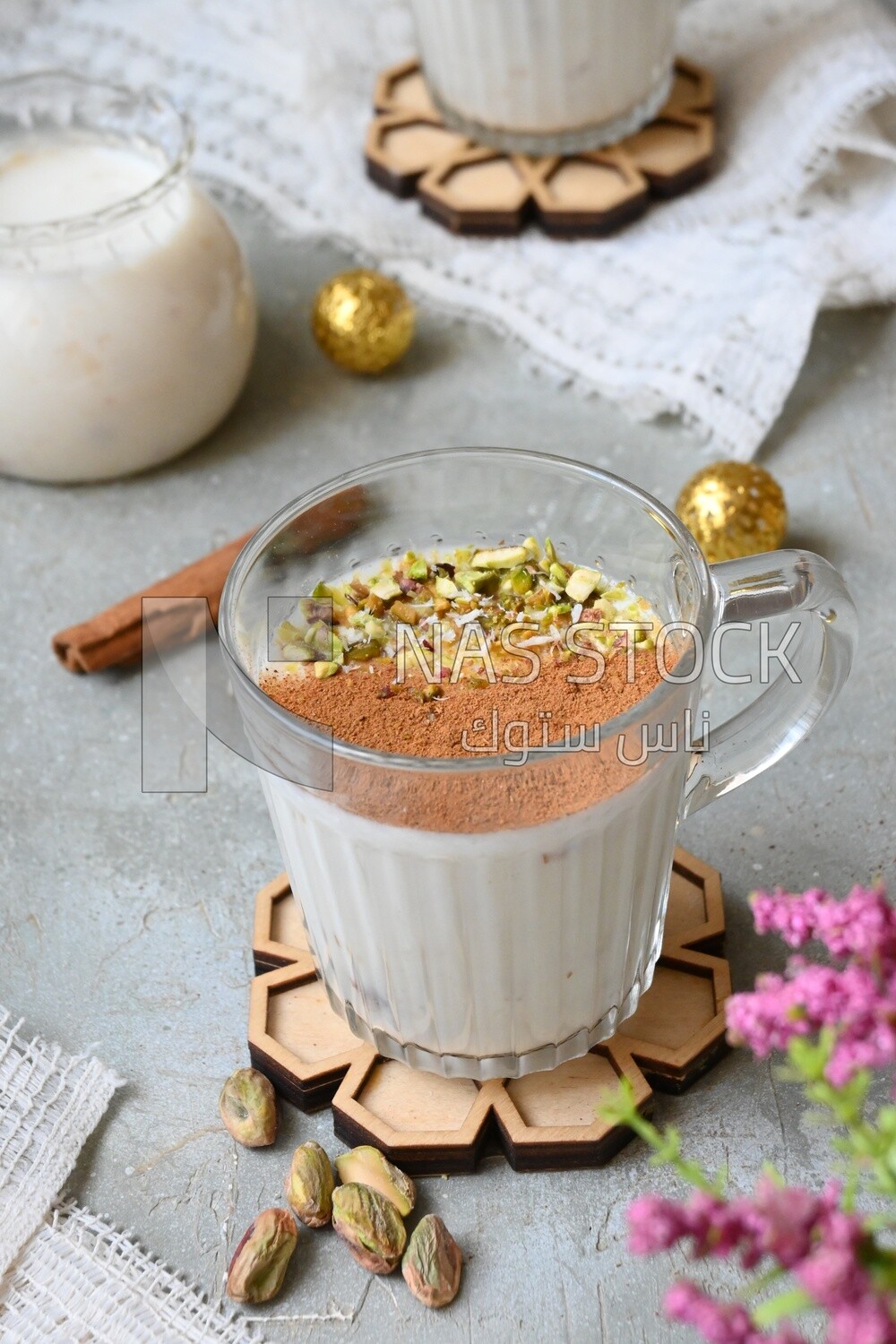 Cup of sahlab with cinnamon and nuts on it