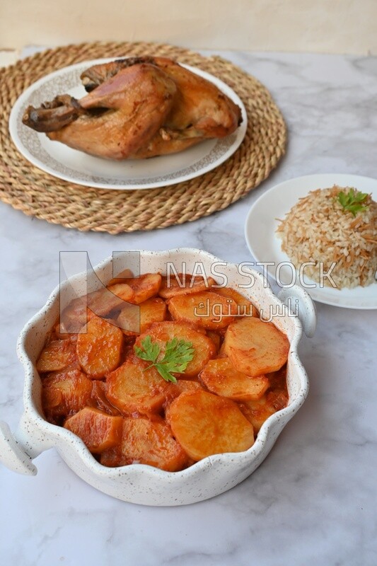 Potato tray sits beside a plate of rice