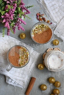 Two cup of sahlab with cinnamon and nuts on it