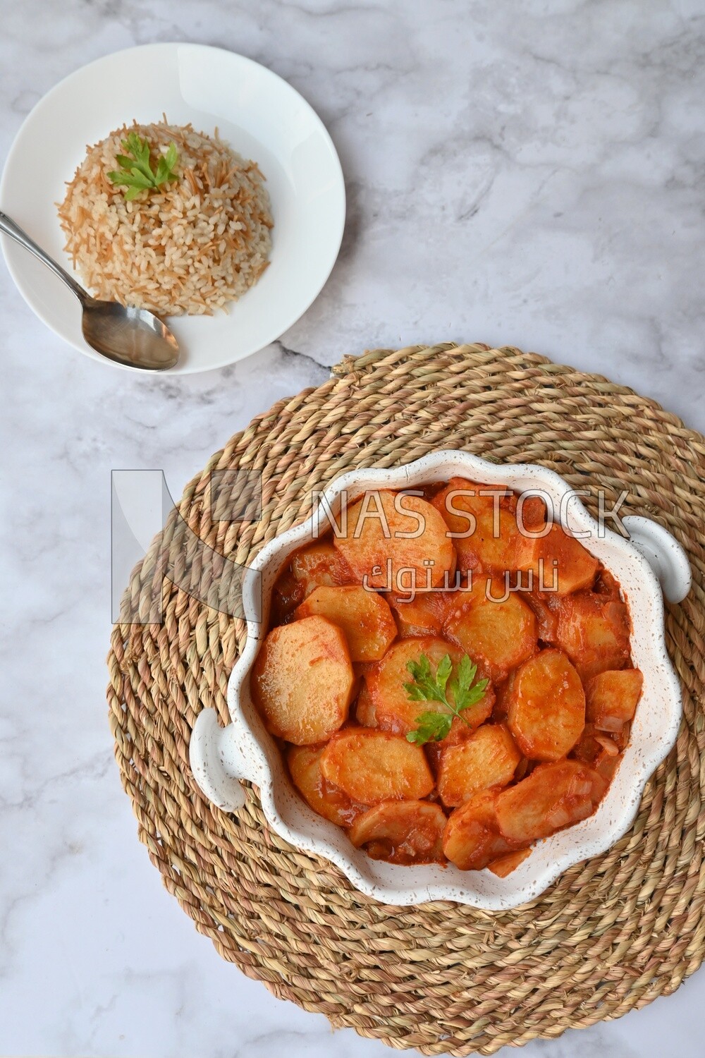 Potato tray sits beside a plate of rice