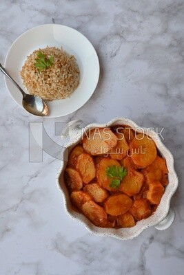 Potato tray sits beside a plate of rice