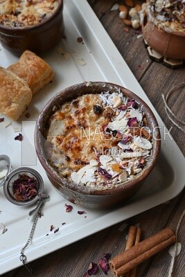 Plate of Umm Ali with nuts on it, famous oriental Arabic sweets, bread and milk sweets