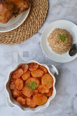 Potato tray sits beside a plate of rice
