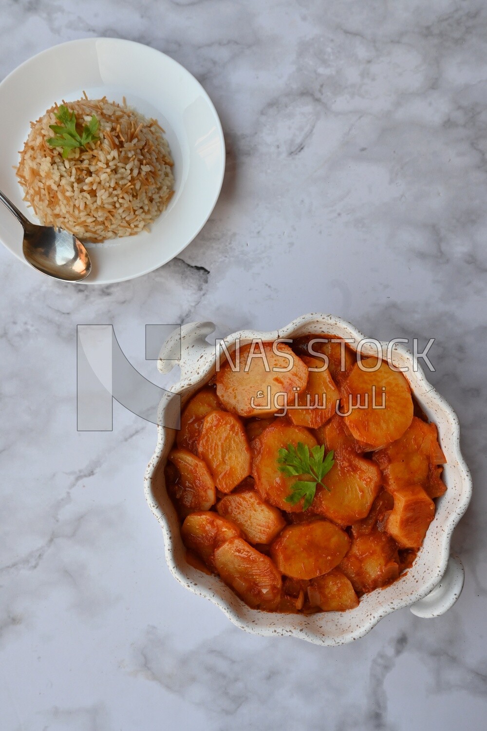 Potato tray sits beside a plate of rice