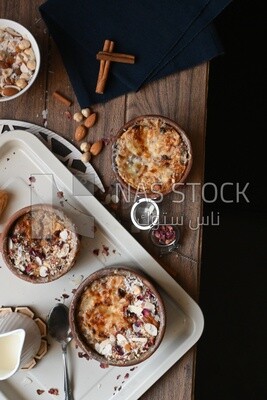 Plate of Umm Ali with nuts on it, famous oriental Arabic sweets, bread and milk sweets
