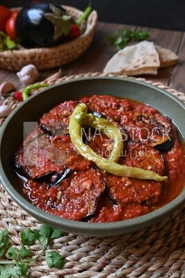 Plate of egyptian mesaka with green pepper on it.