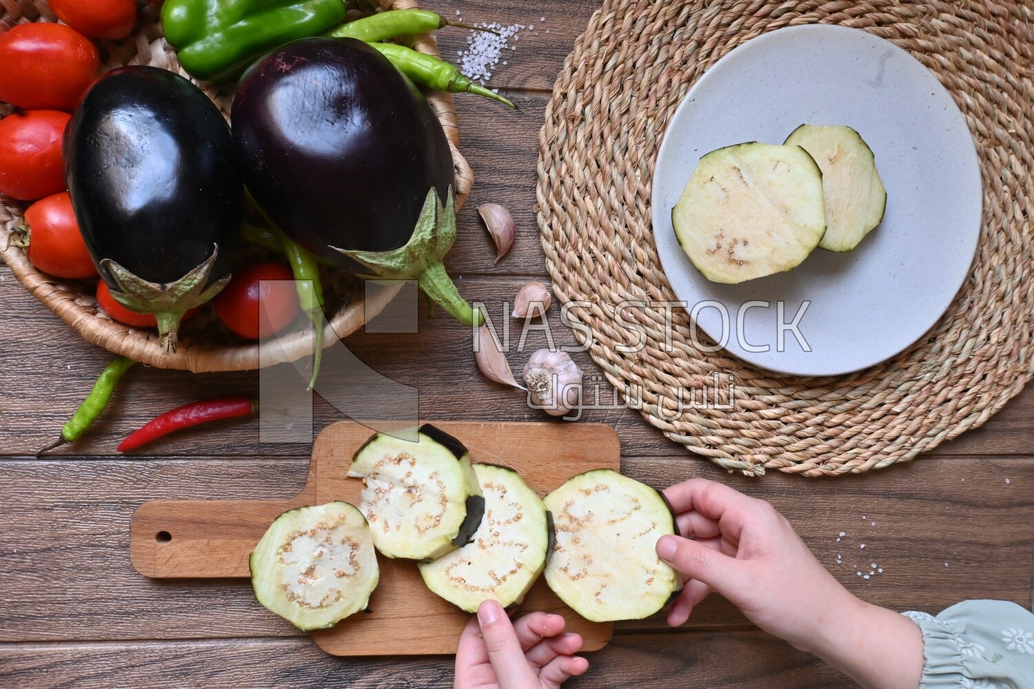 Hand holding the eggplant to cook it