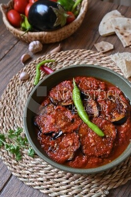 Plate of egyptian mesaka with green pepper on it.