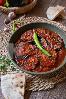 Plate of egyptian mesaka with green pepper on it.