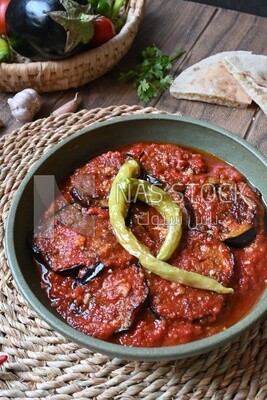Plate of egyptian mesaka with green pepper on it.