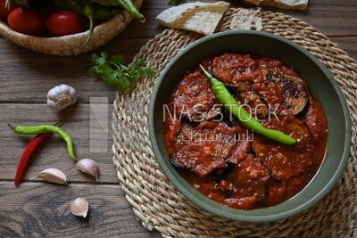 Plate of egyptian mesaka with green pepper on it.