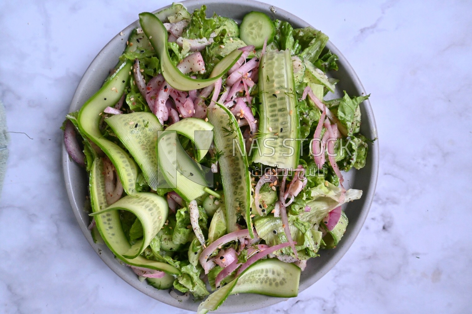 Cucumber salad with onions and lettuce