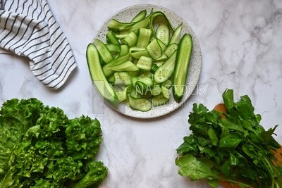 Dishes of lettuce, cucumber and watercress