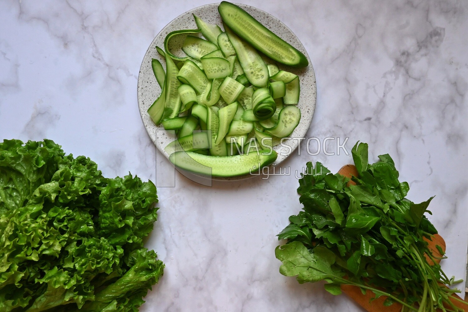 Dishes of lettuce, cucumber and watercress