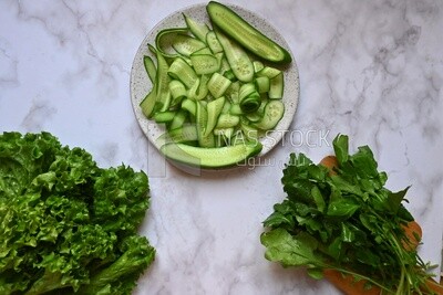 Dishes of lettuce, cucumber and watercress