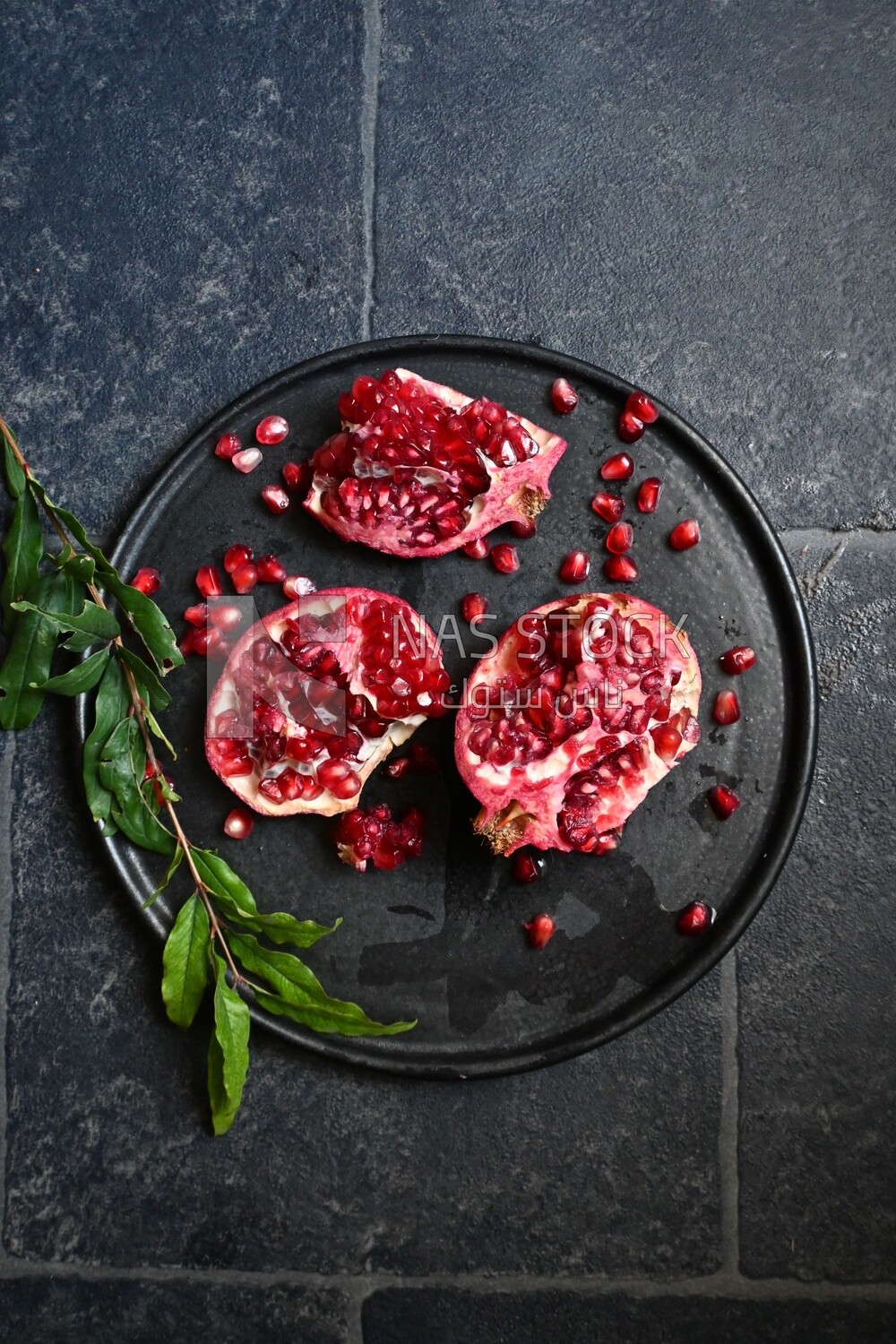 Pomegranates on a black plate​