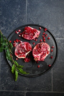 Pomegranates on a black plate​