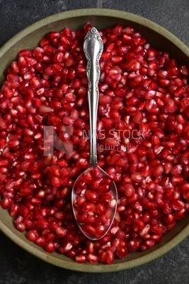 Bowl of pomegranates with a spoon​