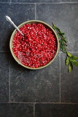 Bowl of pomegranates with a spoon​