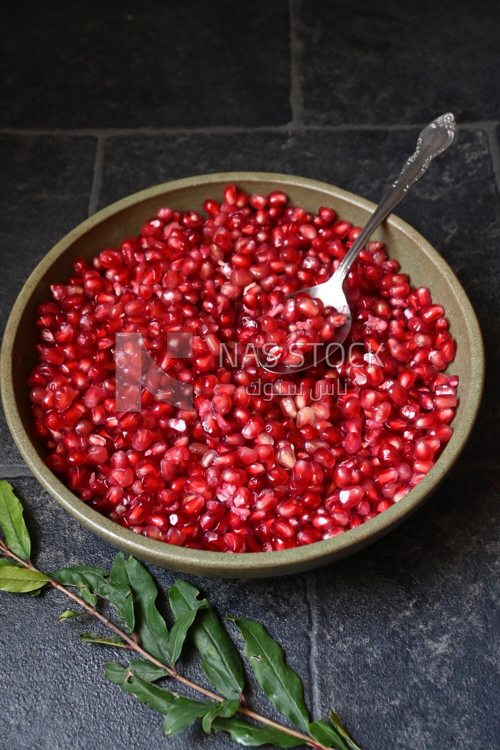 Bowl of pomegranates with a spoon