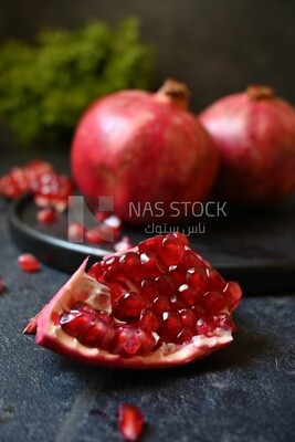 Pomegranates on a black plate​