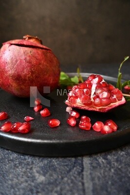 Pomegranates on a black plate​