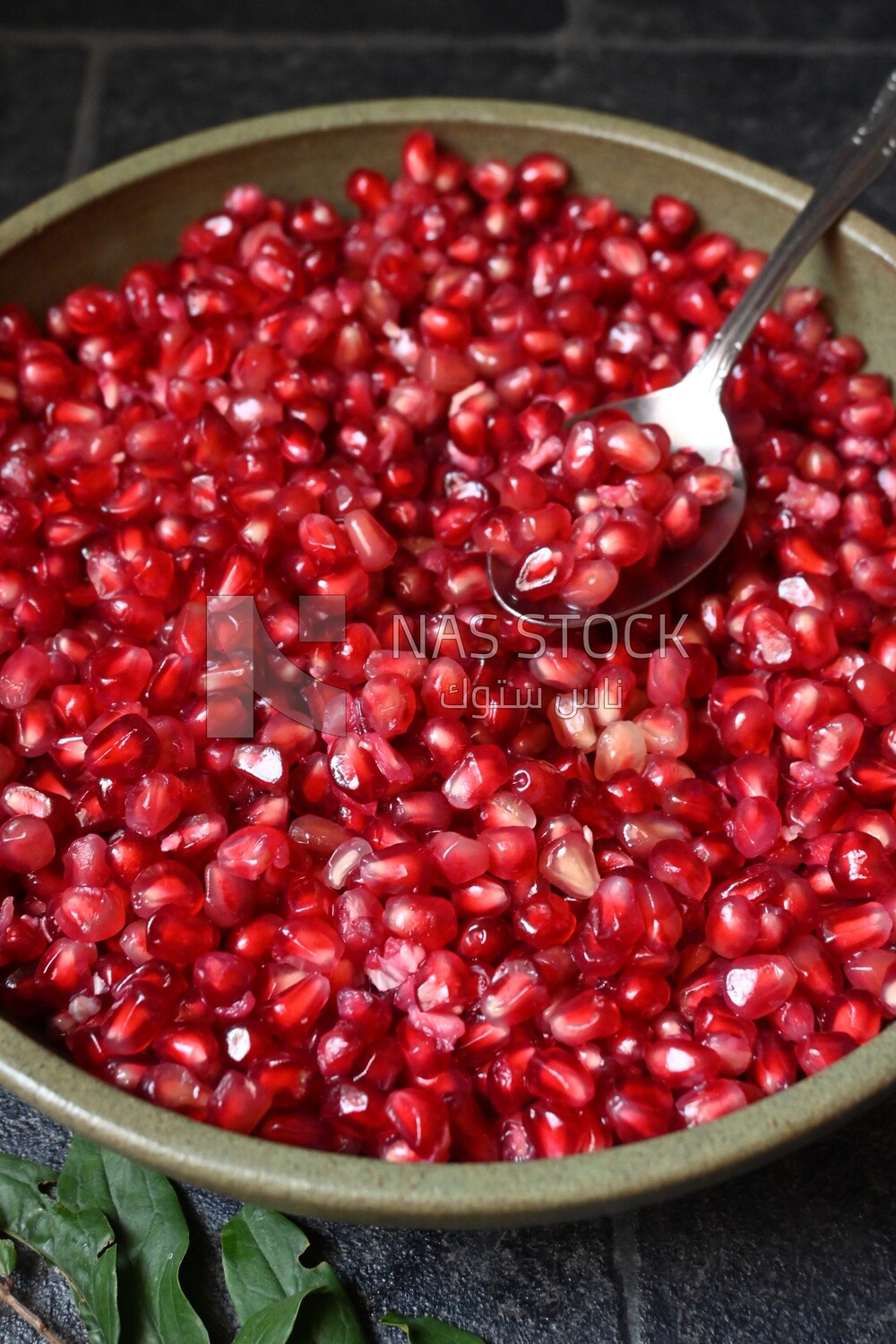 Bowl of pomegranates with a spoon​