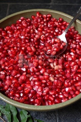 Bowl of pomegranates with a spoon​