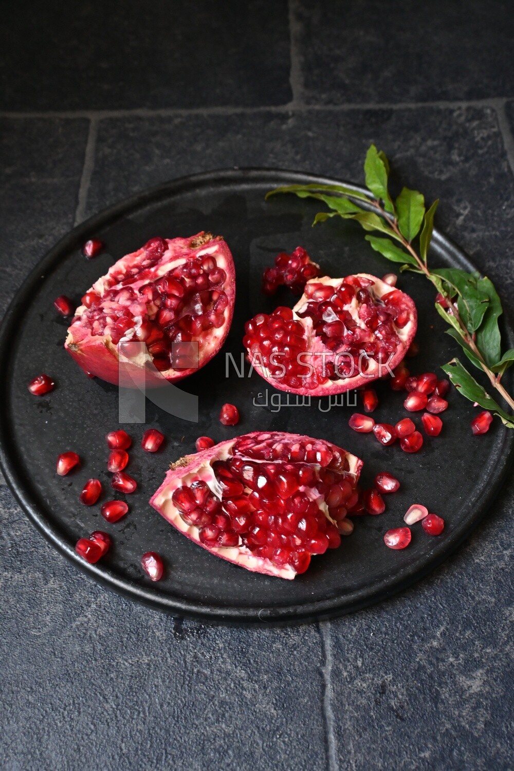 Pomegranates on a black plate​