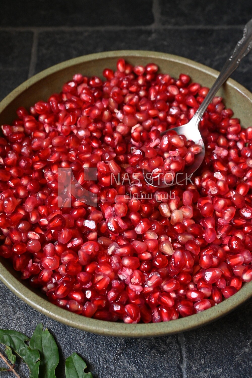 Bowl of pomegranates with a spoon​