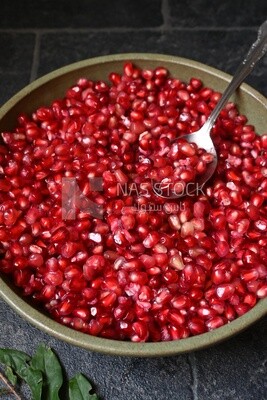 Bowl of pomegranates with a spoon​