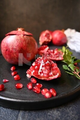 Pomegranates on a black plate​