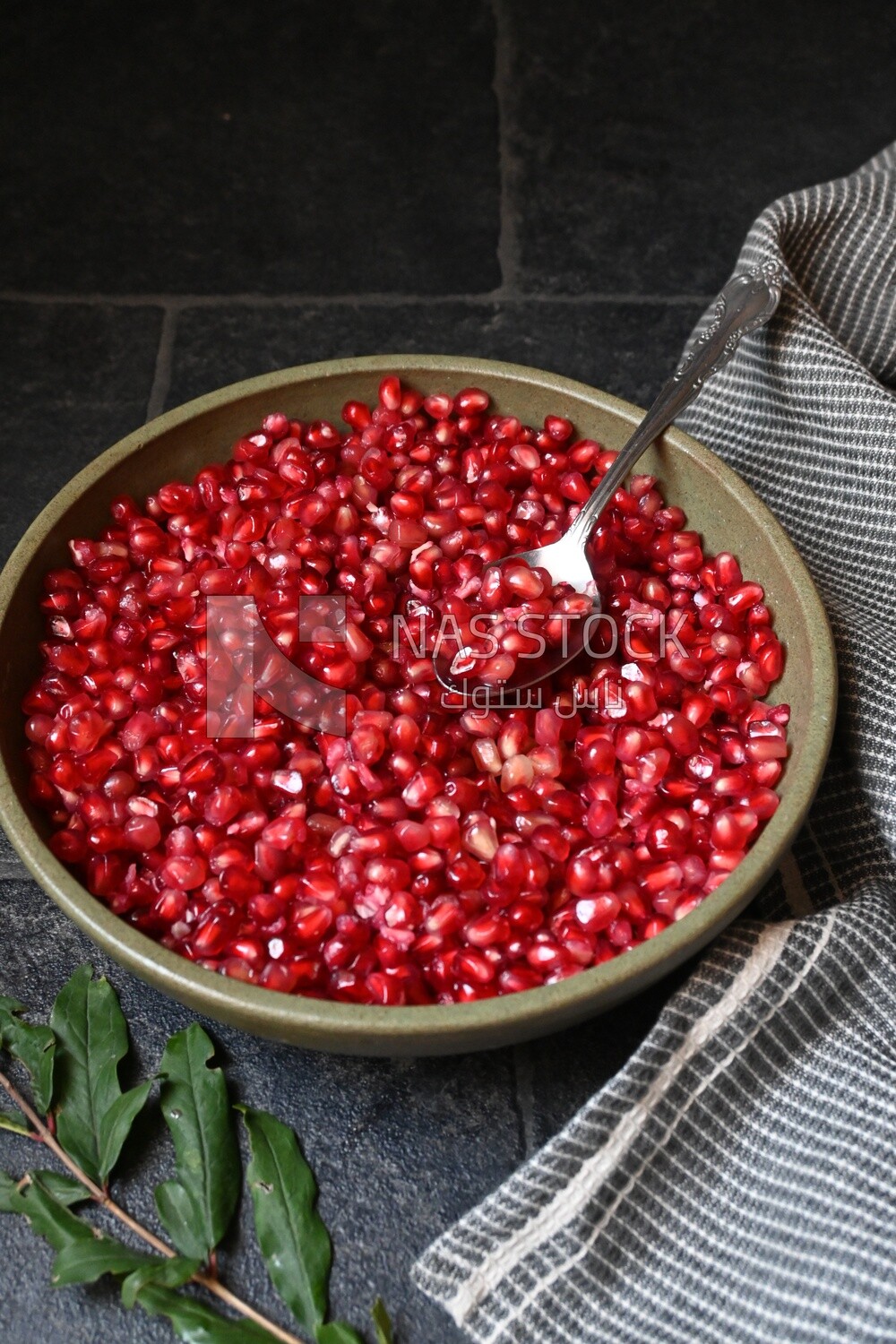 Bowl of pomegranates with a spoon​
