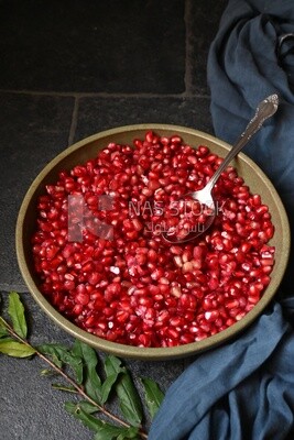 Bowl of pomegranates with a spoon