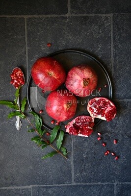 Pomegranates on a black plate​