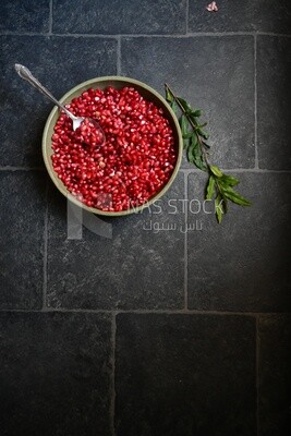 Bowl of pomegranates with a spoon