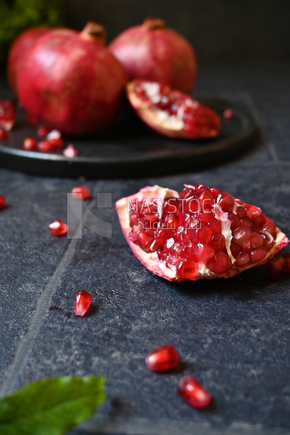 Pomegranates on a black plate​