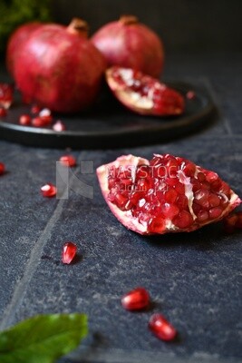 Pomegranates on a black plate​