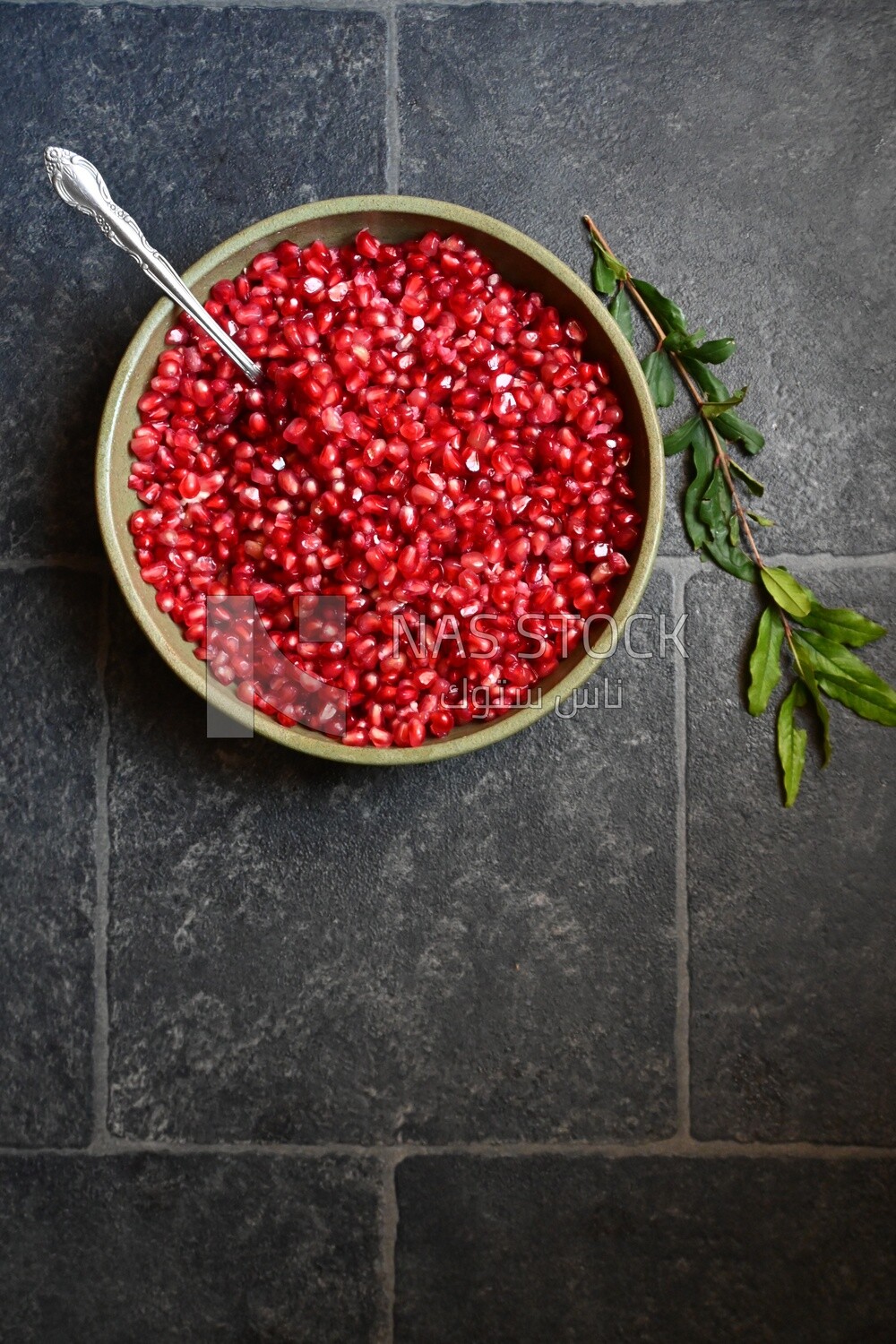 Bowl of pomegranates with a spoon​
