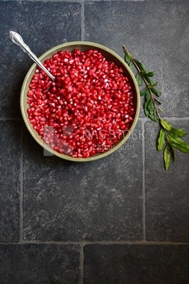 Bowl of pomegranates with a spoon​