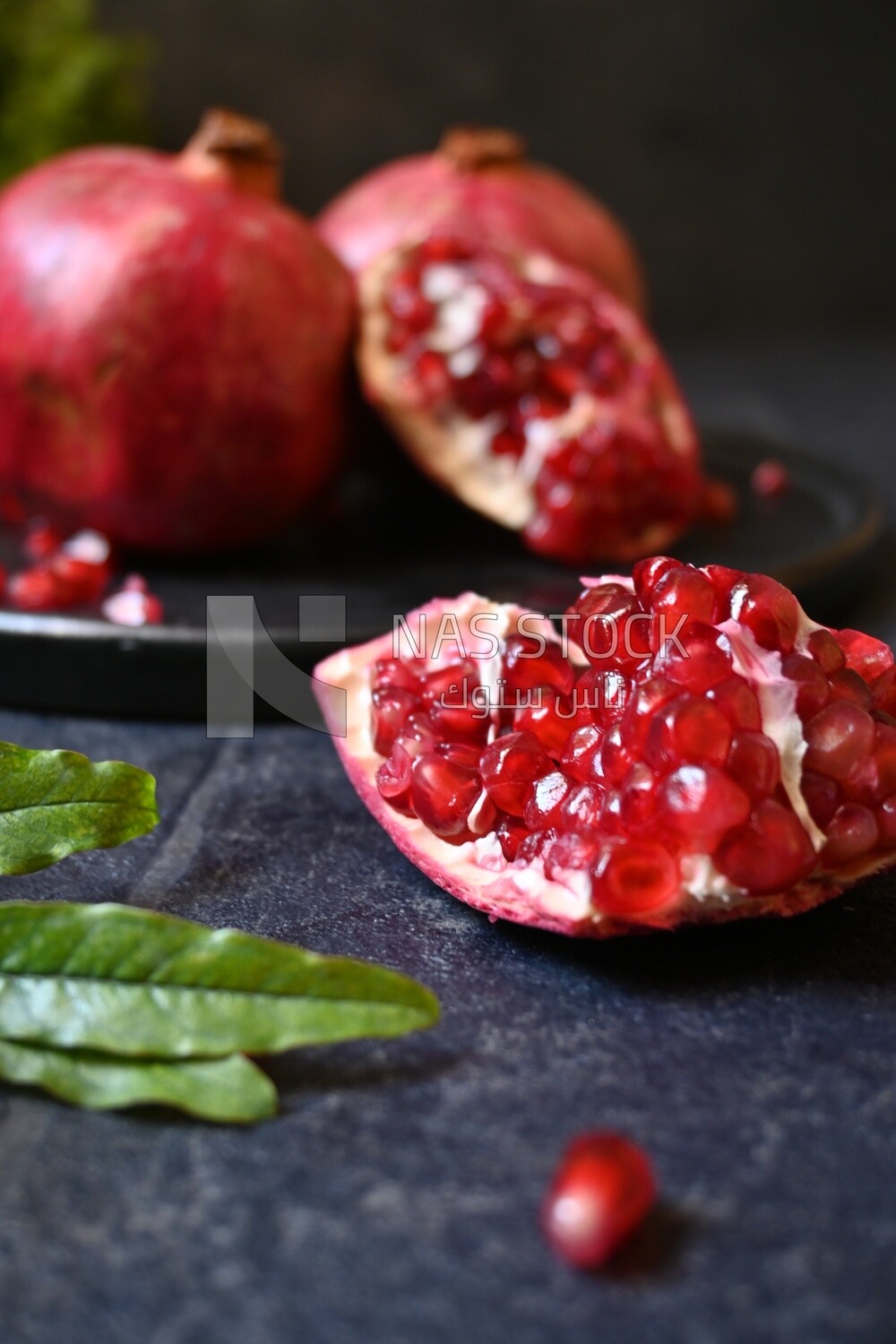 Pomegranates on a black plate​