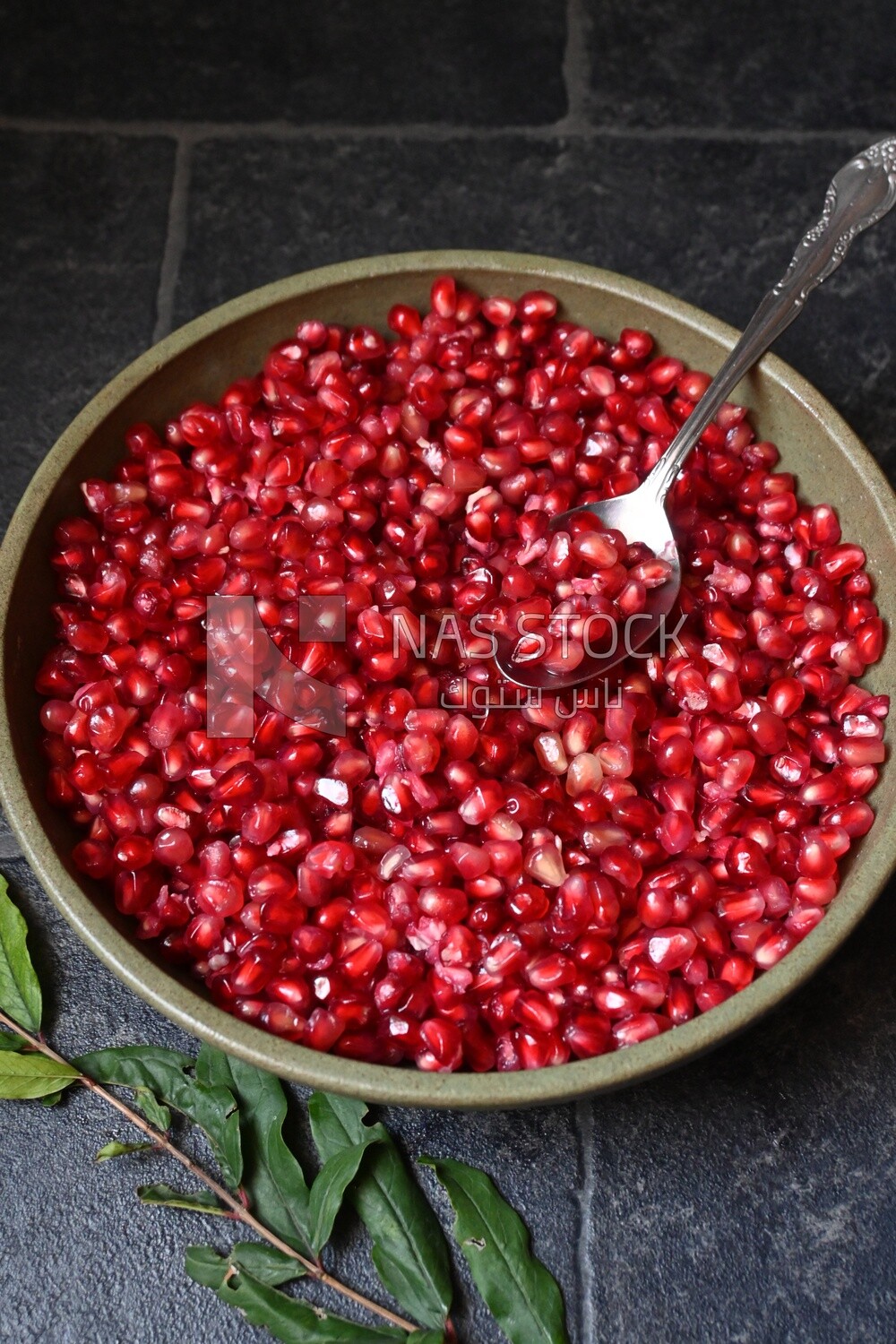 Bowl of pomegranates with a spoon​