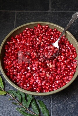 Bowl of pomegranates with a spoon​