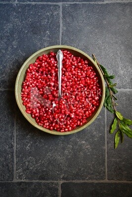 Bowl of pomegranates with a spoon​