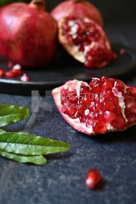 Pomegranates on a black plate​